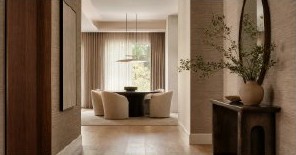 Quiet neutral bedroom with layered wallcovering and soft light
